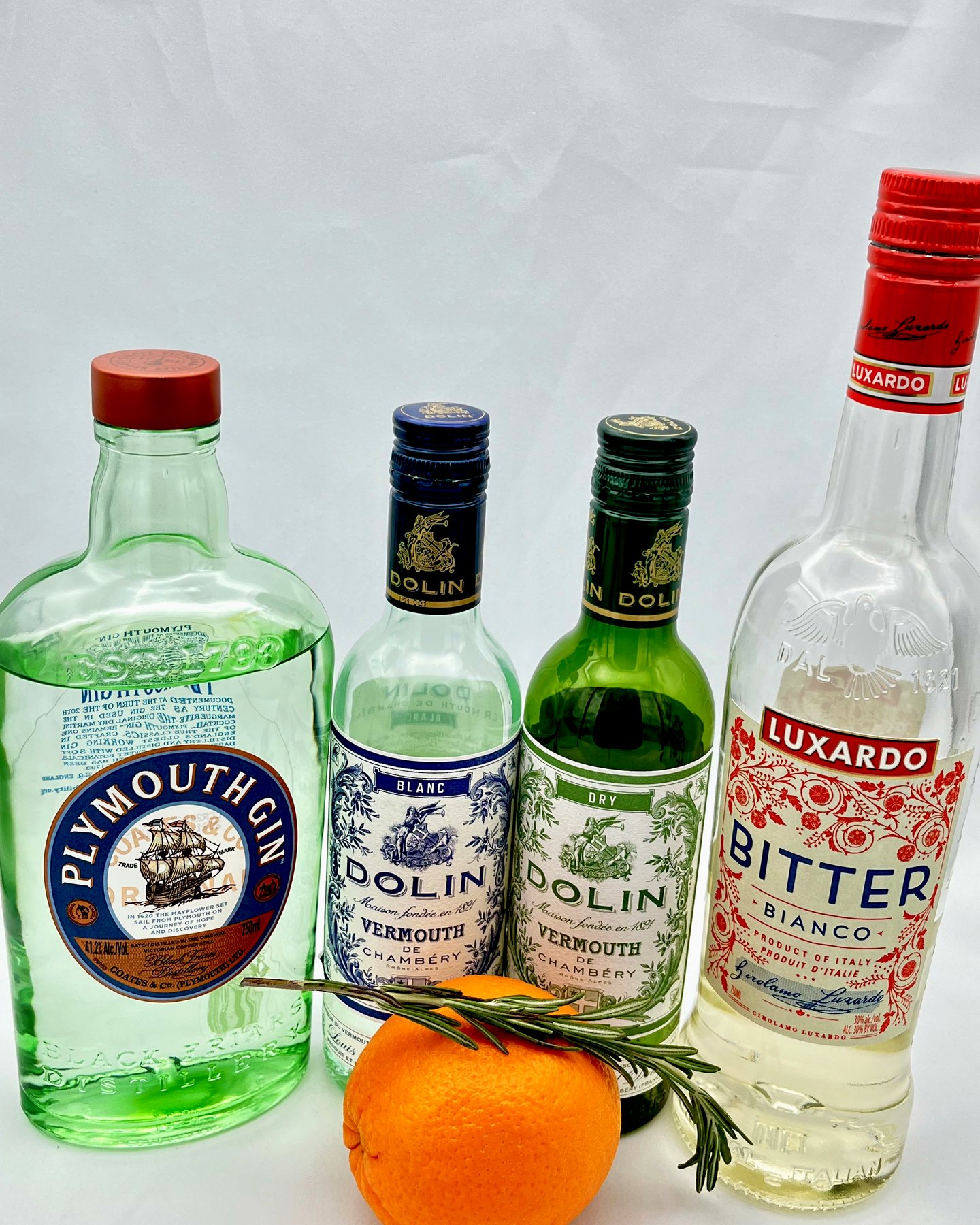 Bright cocktail ingredients with citrus and premium bottles