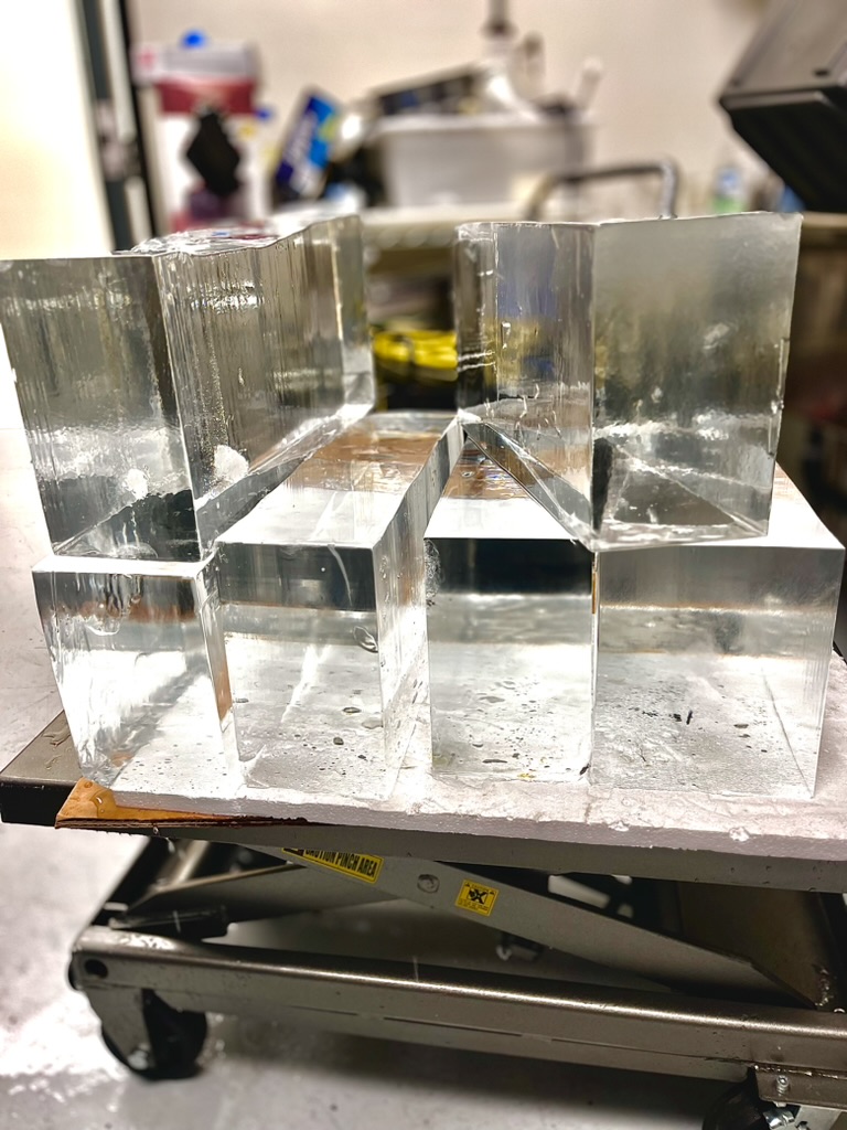 Large clear ice blocks staged for premium cocktail service