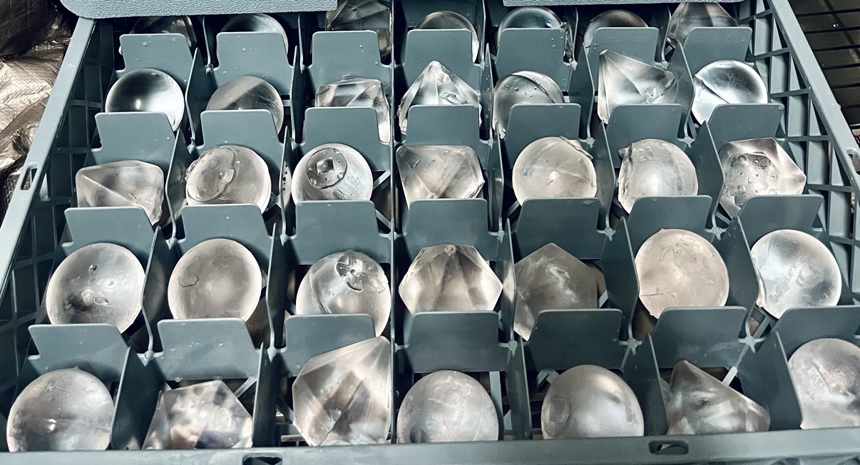 Rack of clear ice diamonds and spheres prepared for event service